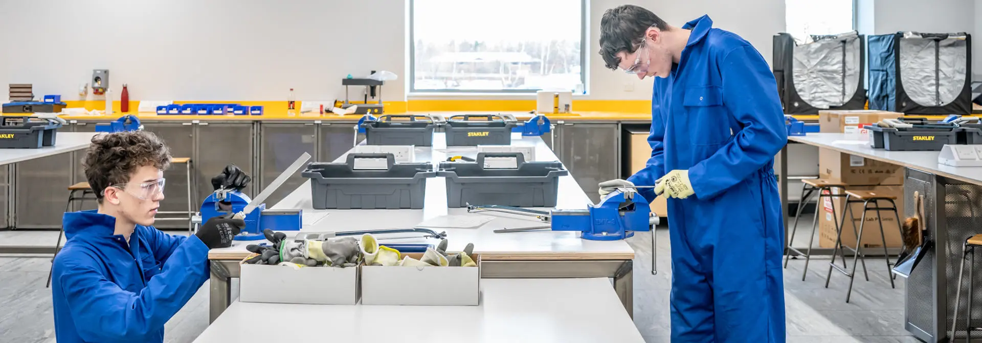 Two students using a lathe in GRID