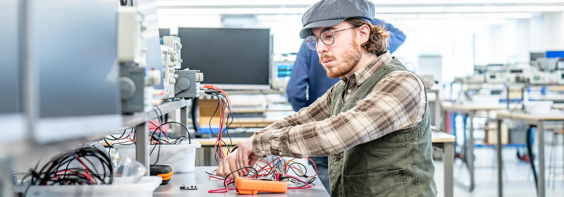 Student working on electrical equipment in a lab