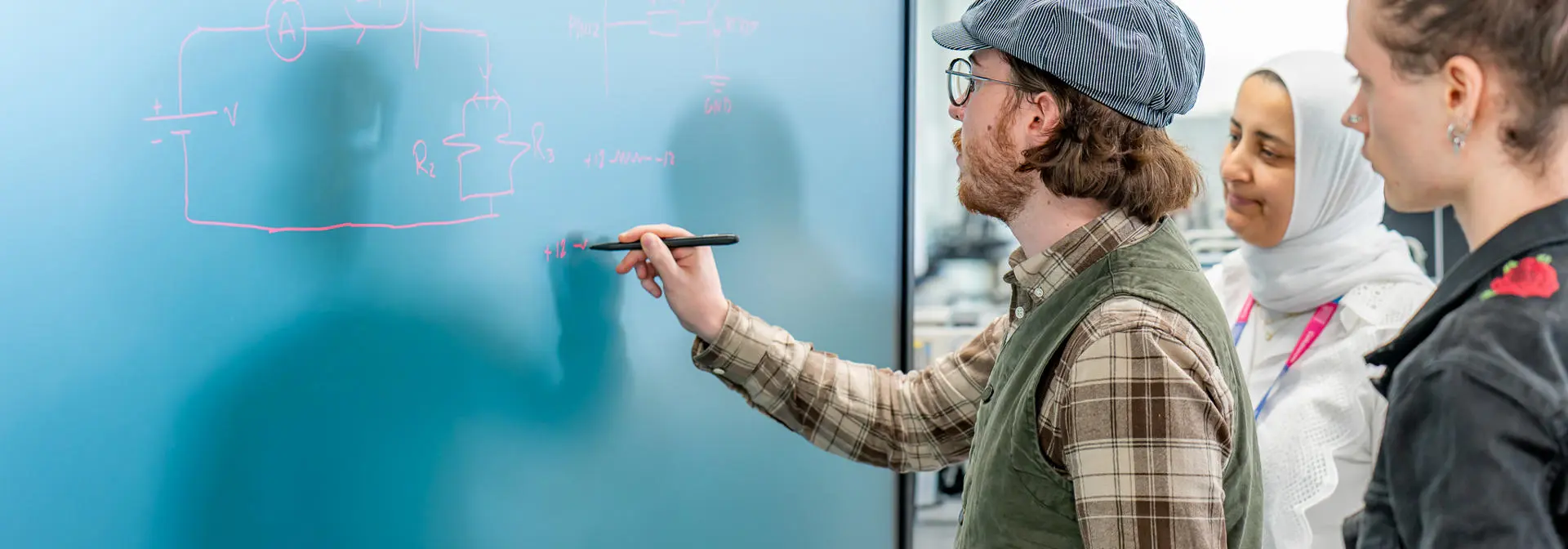 People working together on a digital blackboard