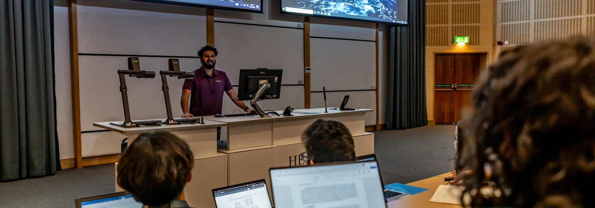 Student giving a presentation in a lecture room