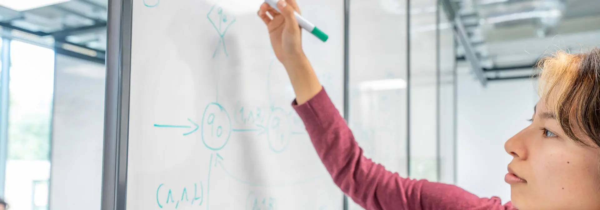Student writing on a whiteboard
