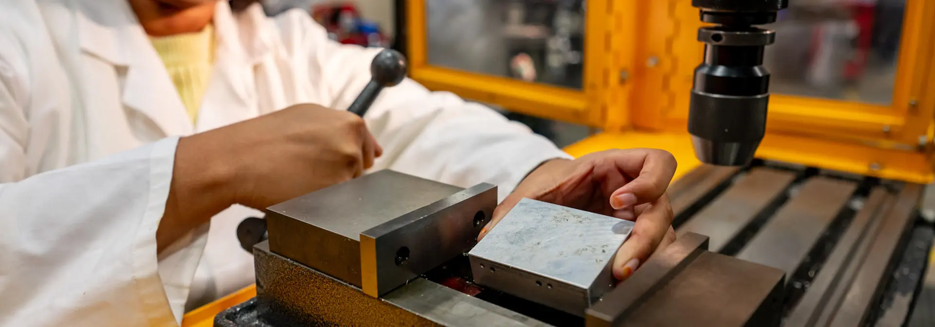 Student using mechanical engineering equipment