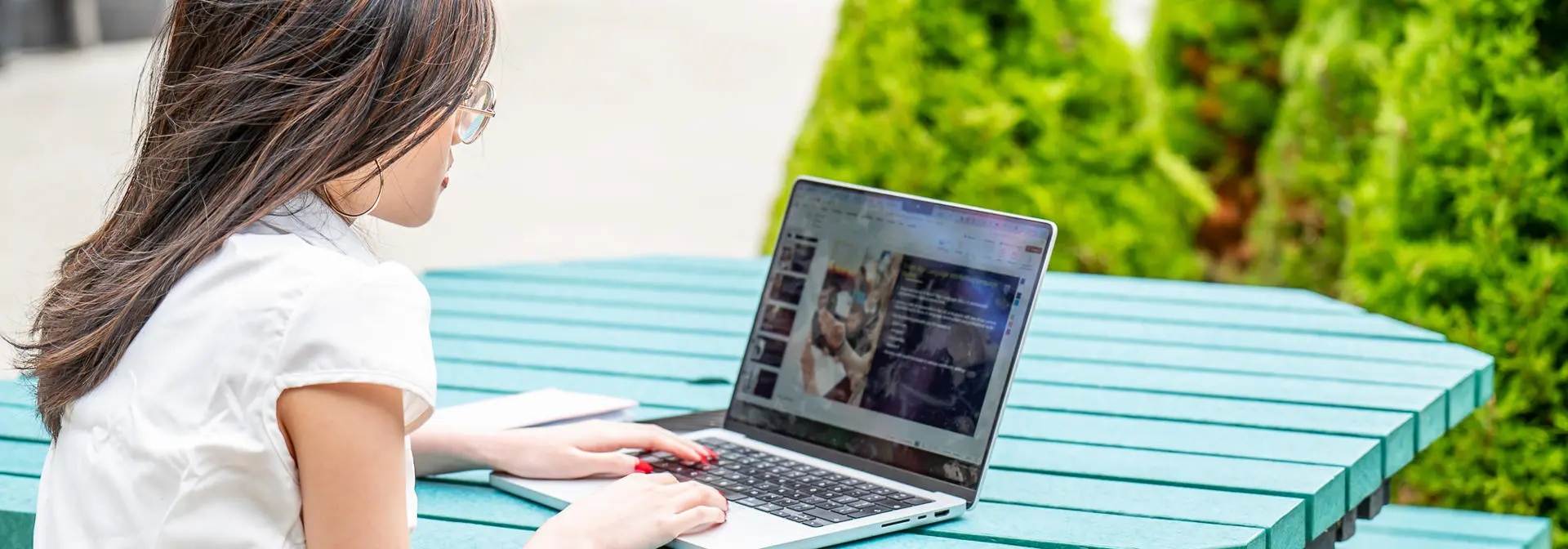 Student working on a laptop outdoors