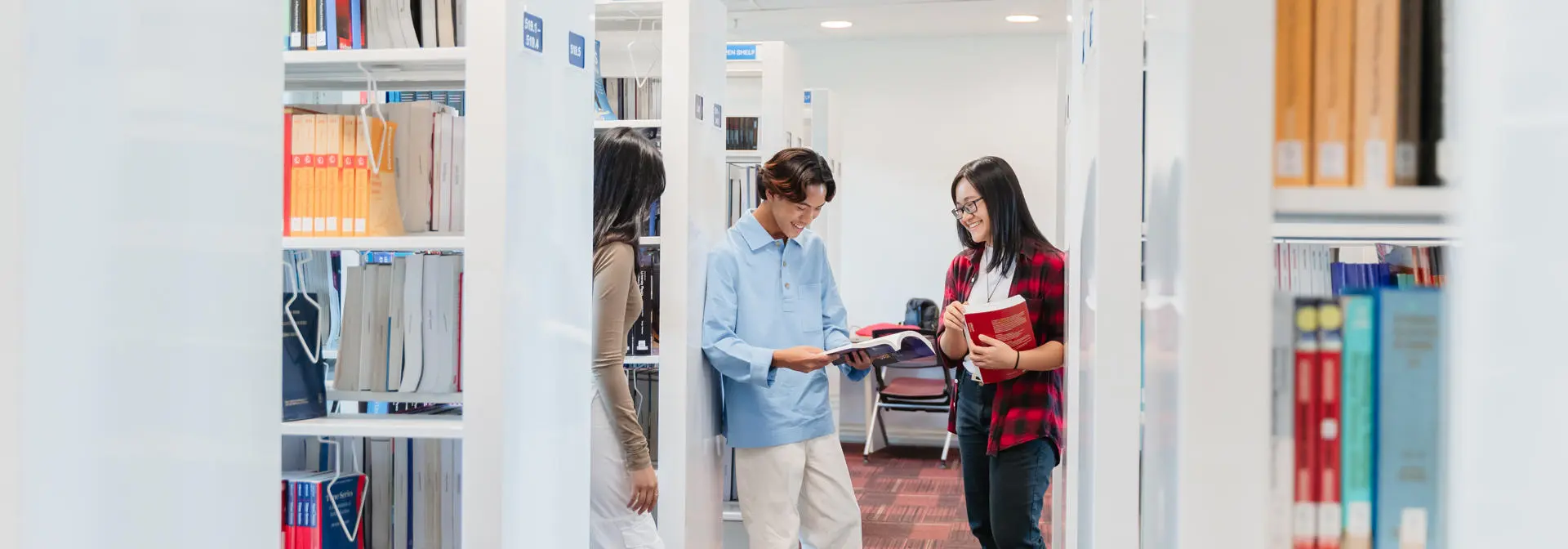 Students reading books in library