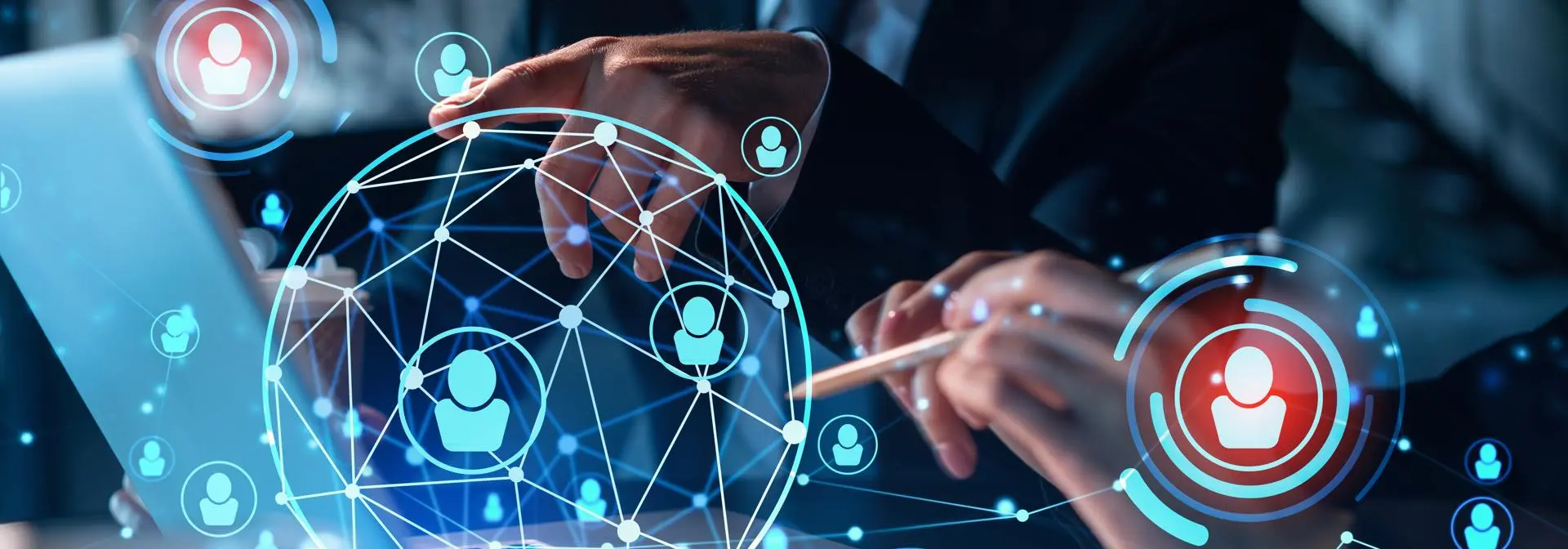 Two individuals collaborate at a laptop, with digital icons representing people and management