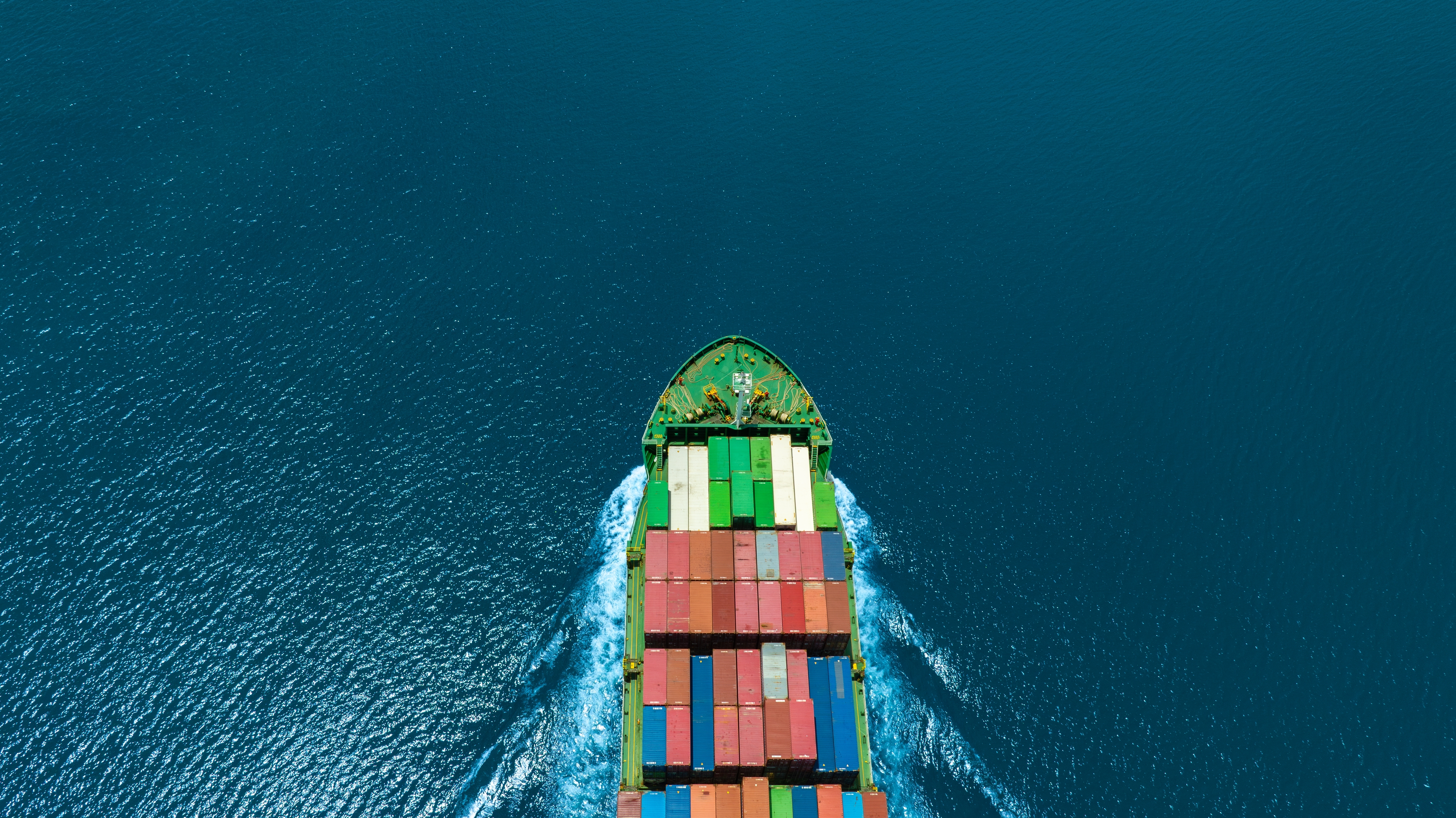 shipping containers on a ship sailing across waters
