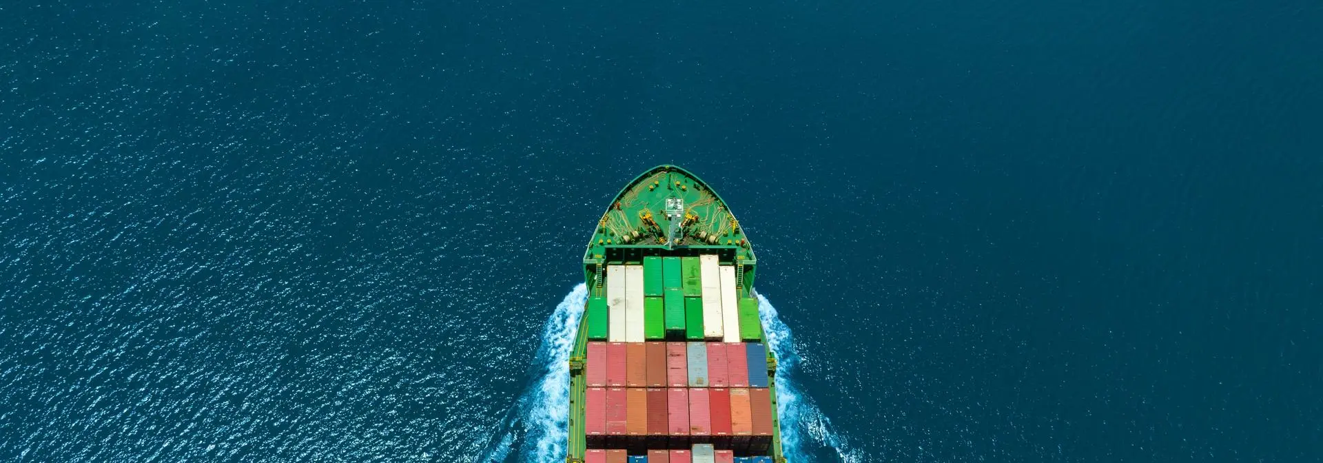 shipping containers on a ship sailing across waters