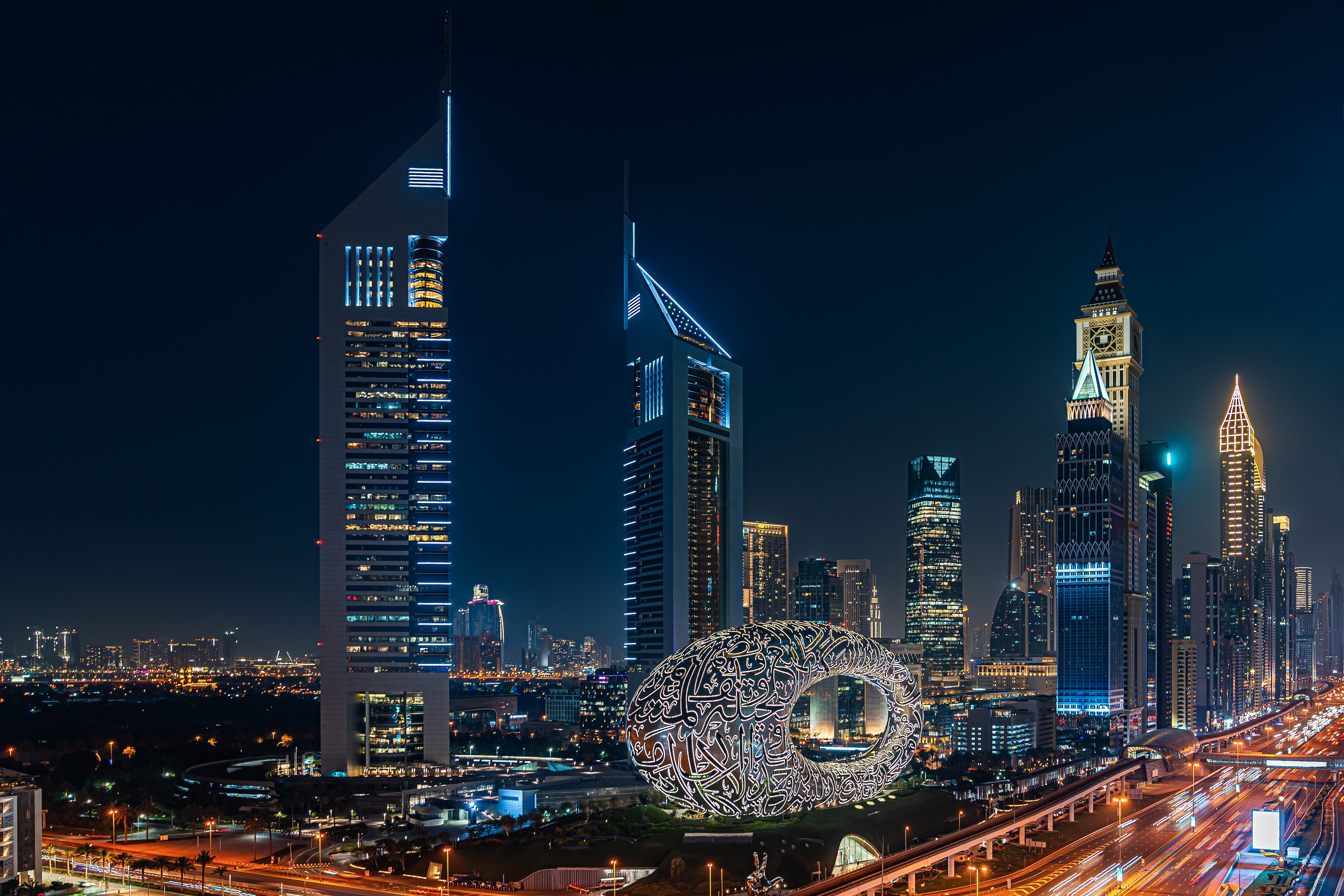 Nighttime view of Dubai with the Museum of the Future and surrounding skyscrapers