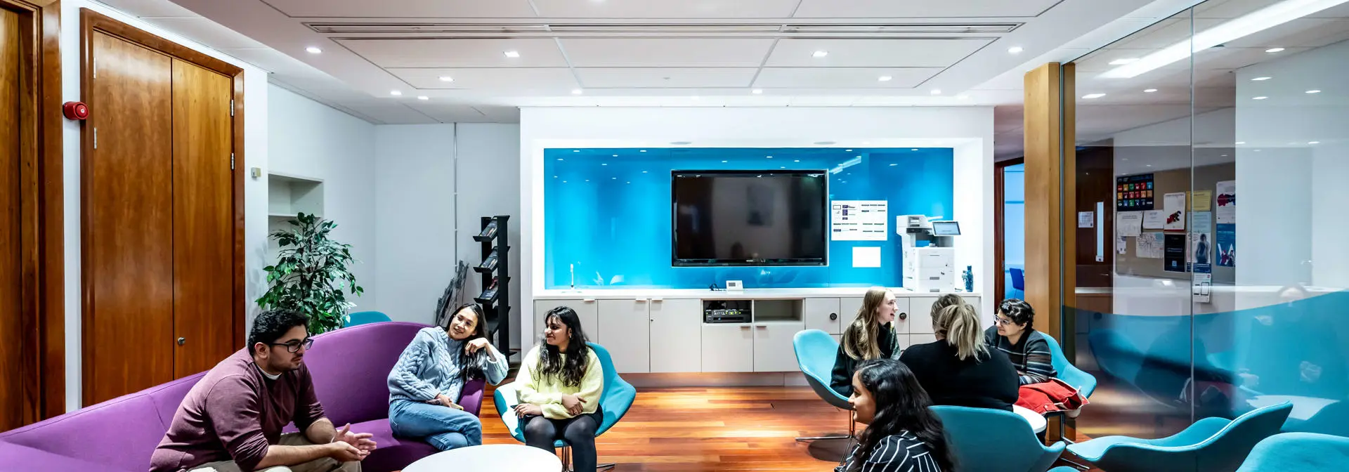 Students sit in the Lumsden Suite break out area at Edinburgh Business School