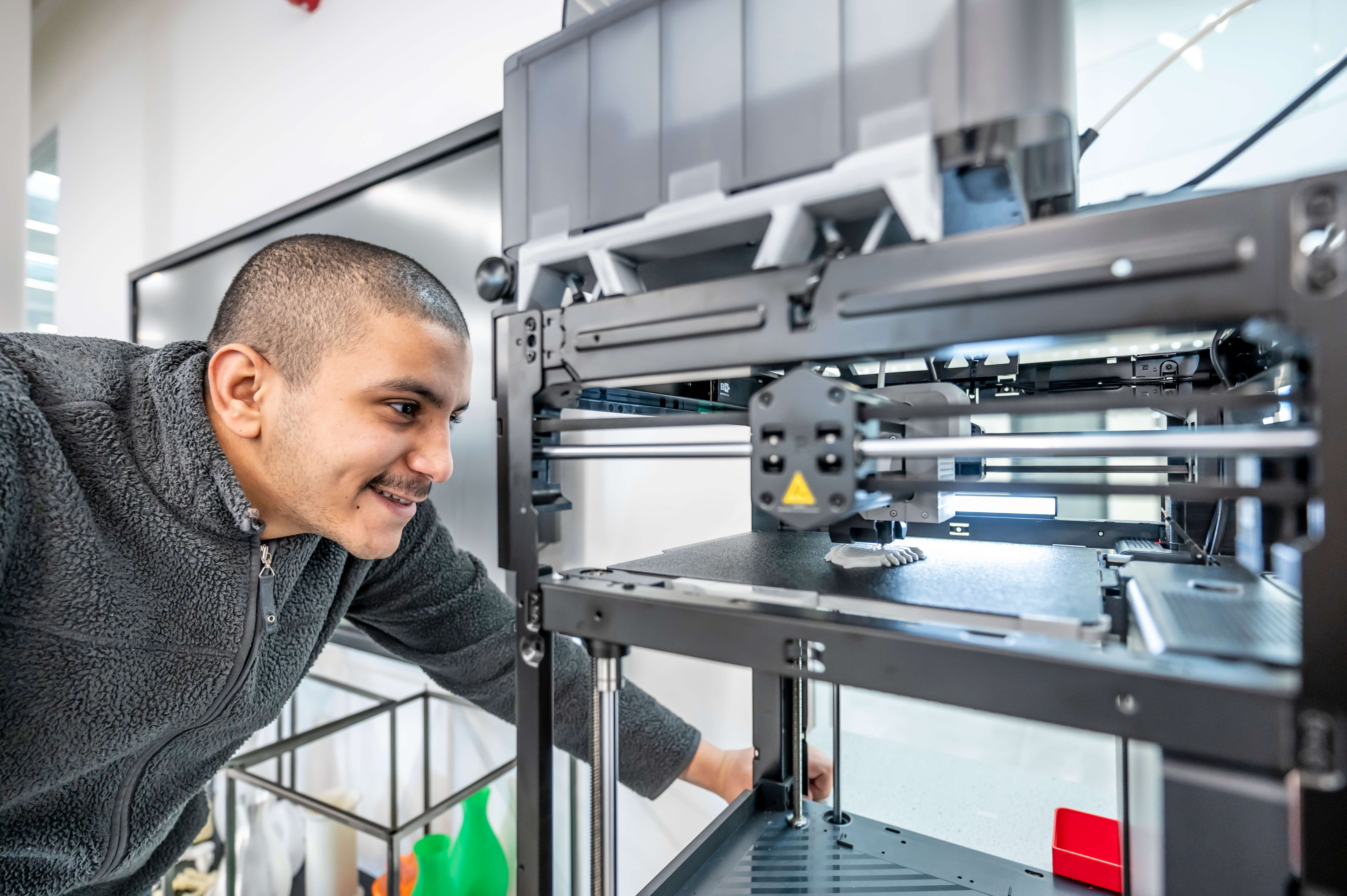 Mechanical Engineering student using a 3-D printer