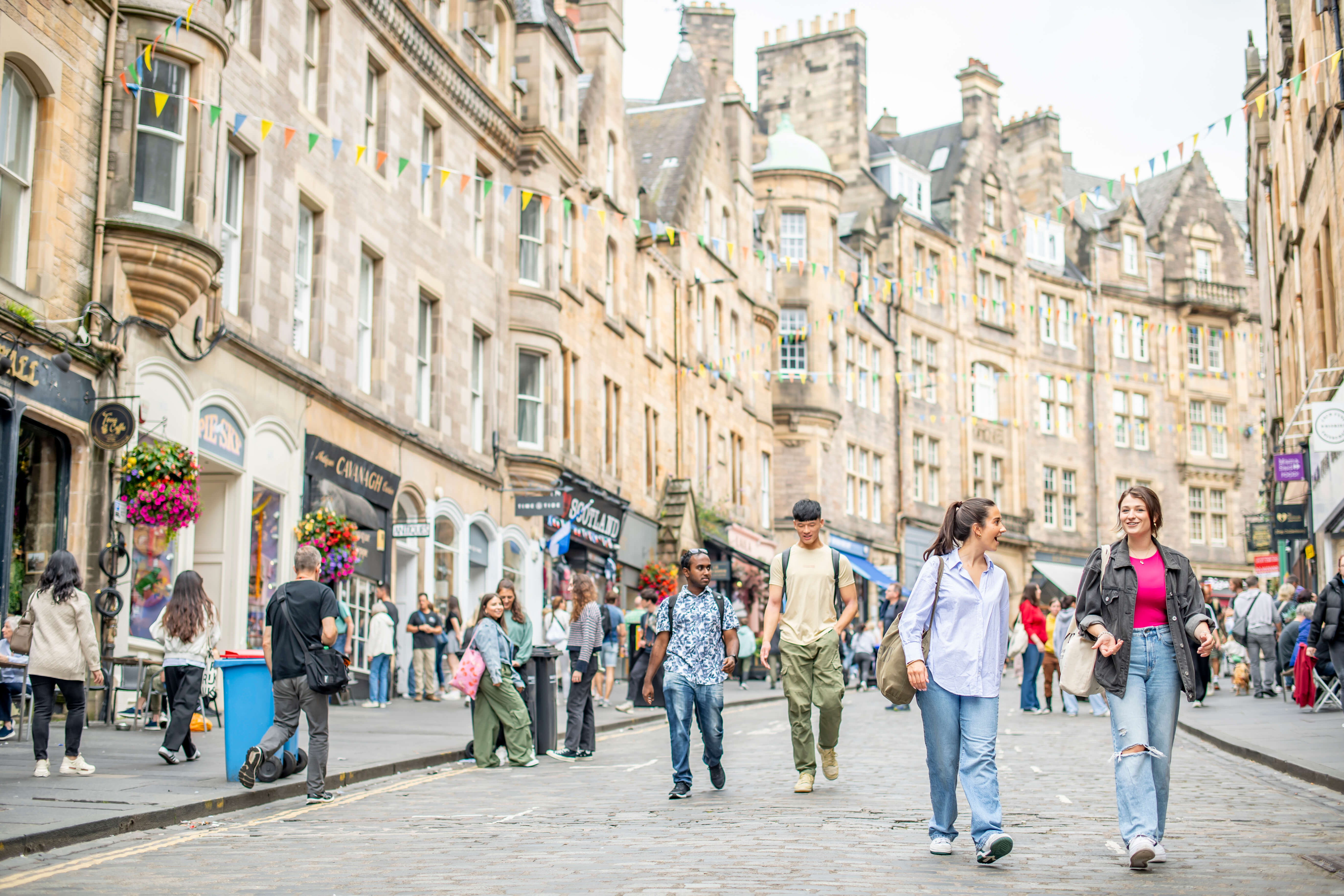 Students chatting whilst walking down Cockburn Street in the City centre. 