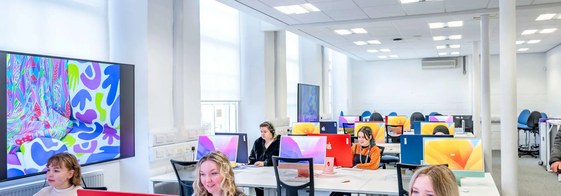 A group of students using Macintosh desktop computers