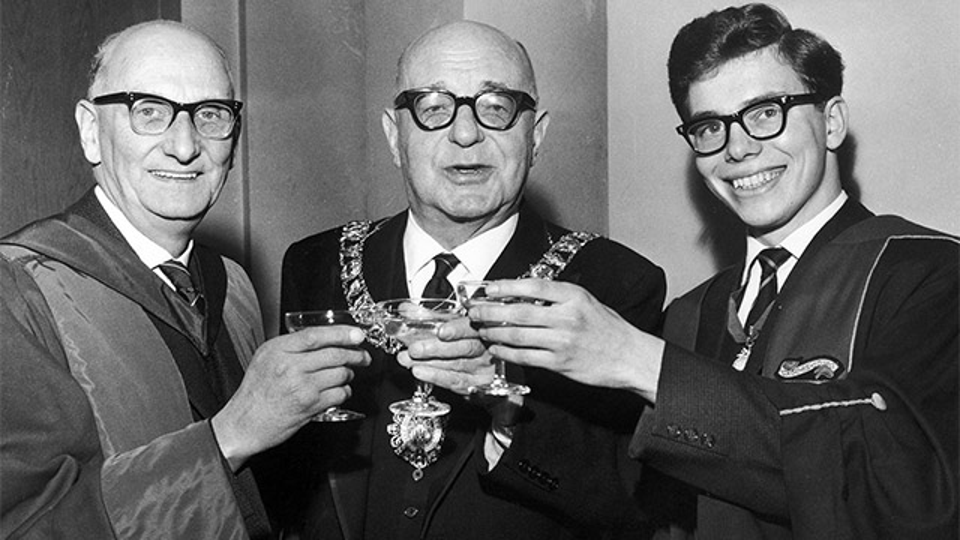 Principal Hugh Nisbet, Sir Duncan Weatherstone chair of the board of governors and Stefan Kay, SRC president toasting the new University Royal Charter cheers