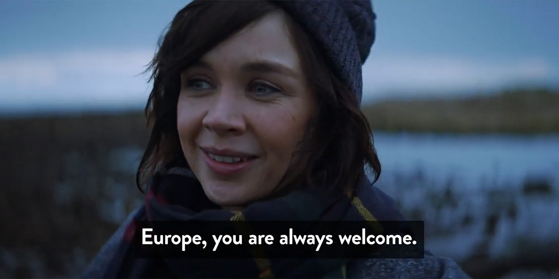 Young Scottish woman in winter clothing at a coastal location in Scotland