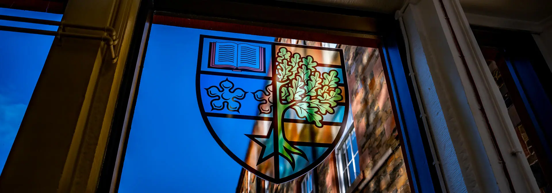 The Heriot-Watt University badge in a stained glass window.
