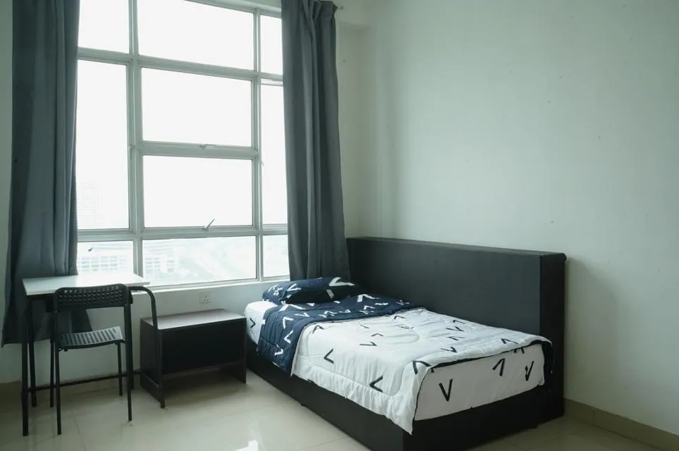 Bedroom with single bed, bedside table, smal desk and chair, big window and tiled floor