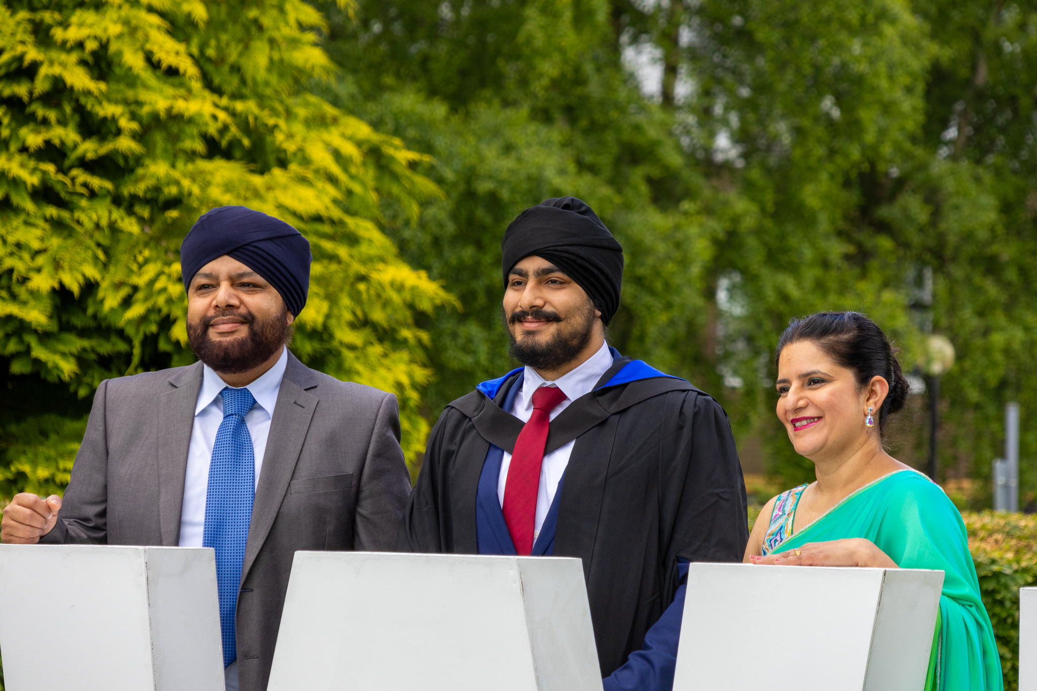 An undergraduate posing for photographs at graduation in Edinburgh.