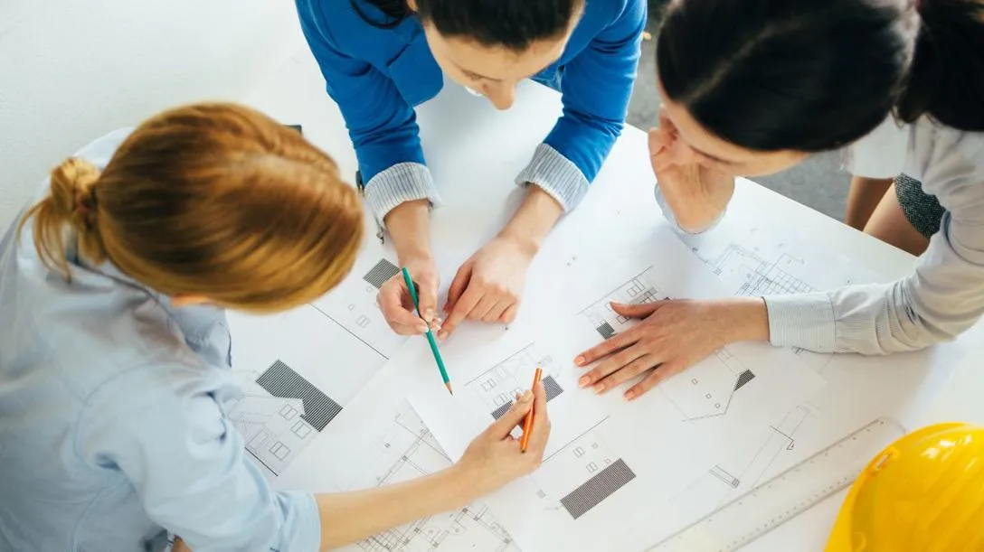 Students looking at housing model diagrams