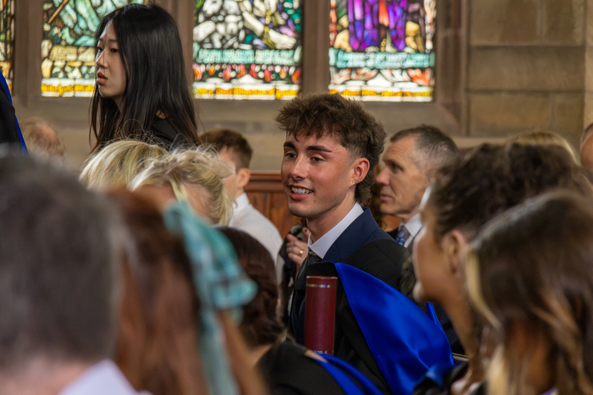Graduates in a hall at  graduation ceremony