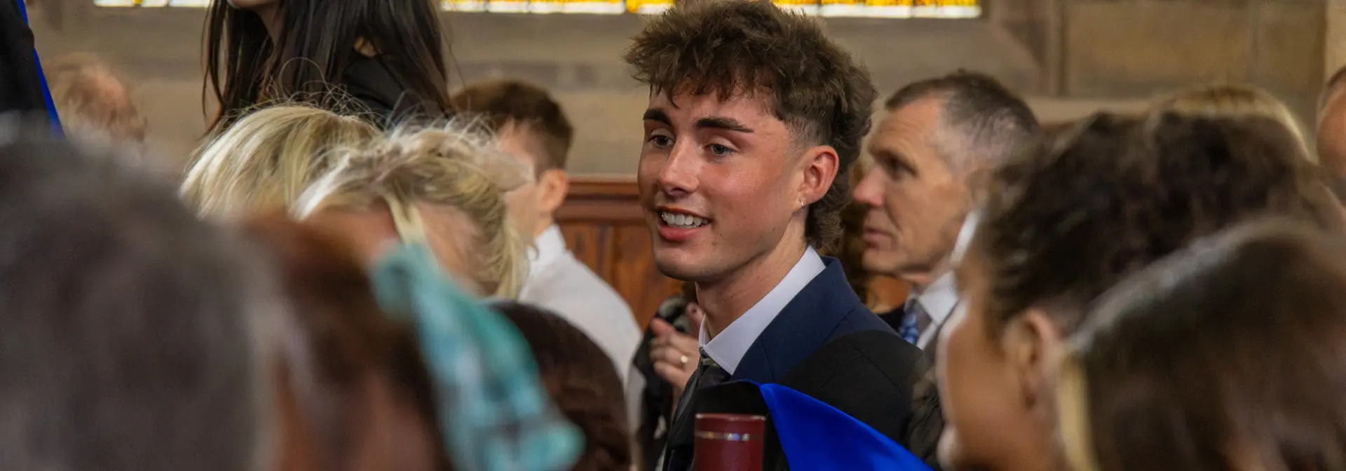 Graduates in a hall at graduation ceremony