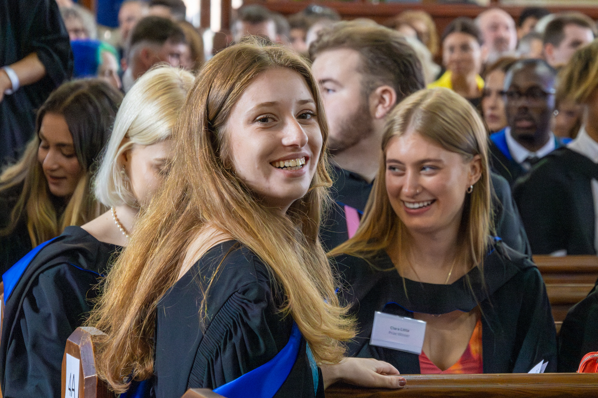 A student sits in a booth in the graduation ceremony. 