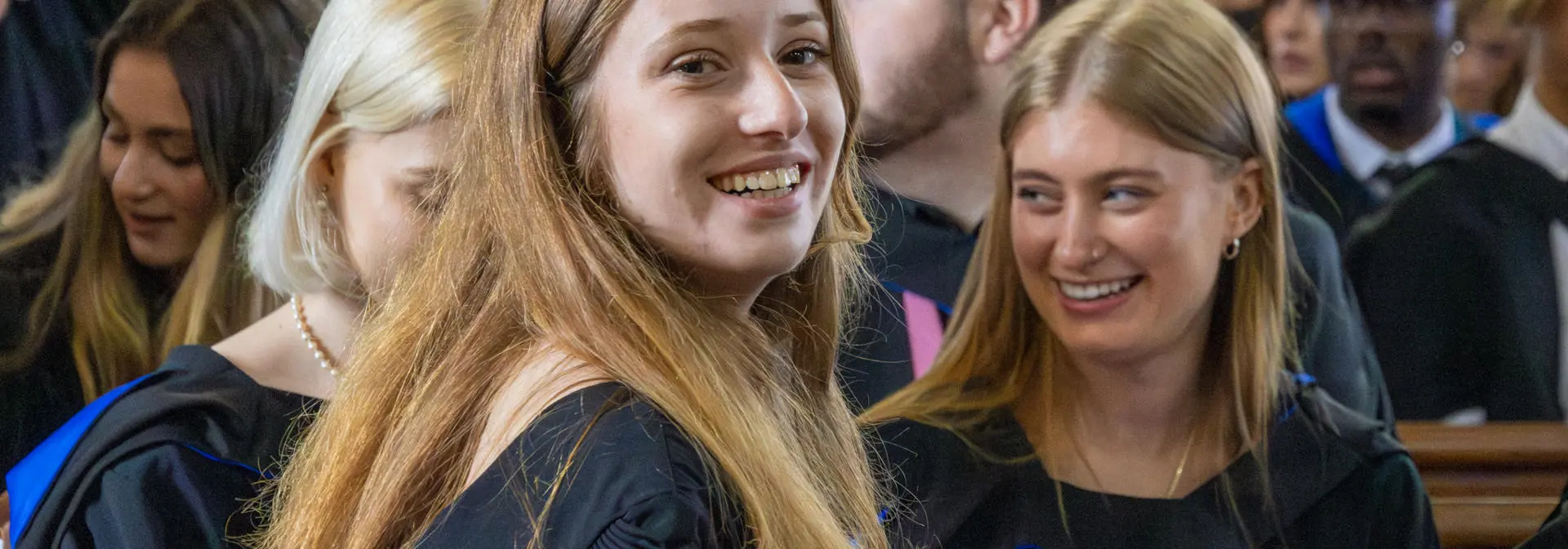 A student sits in a booth in the graduation ceremony.