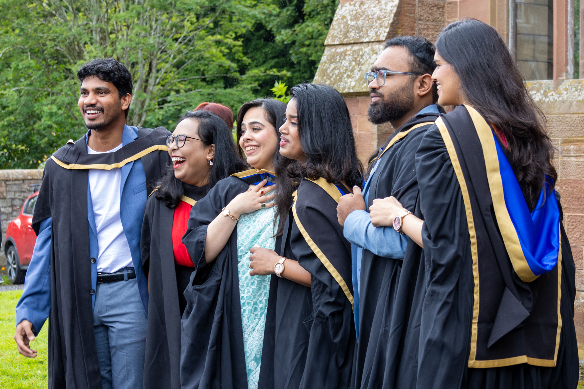 Graduates at the Scottish Borders campus post for photographs outside the ceremony hall.
