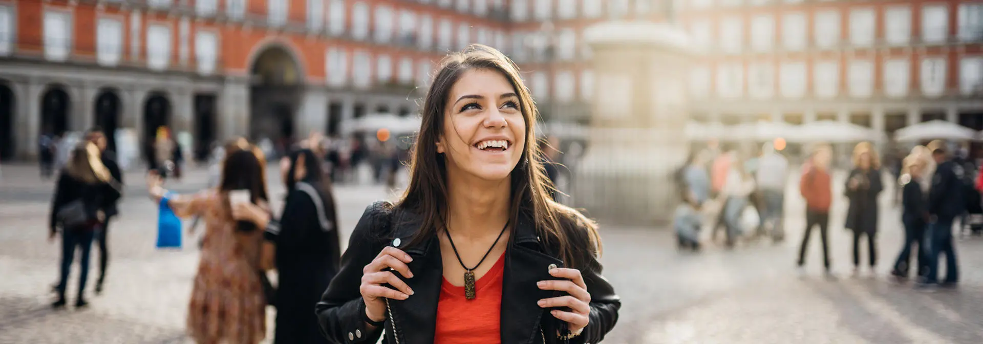 A student walking through a European city square on an exchange.