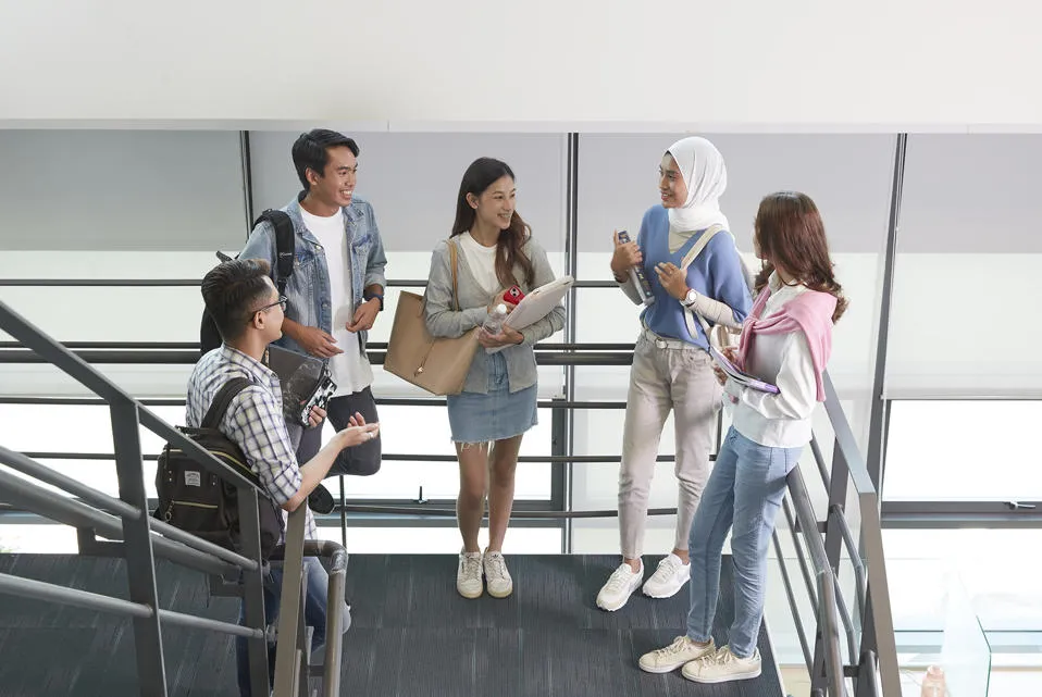Students having a conversation in the stairwell