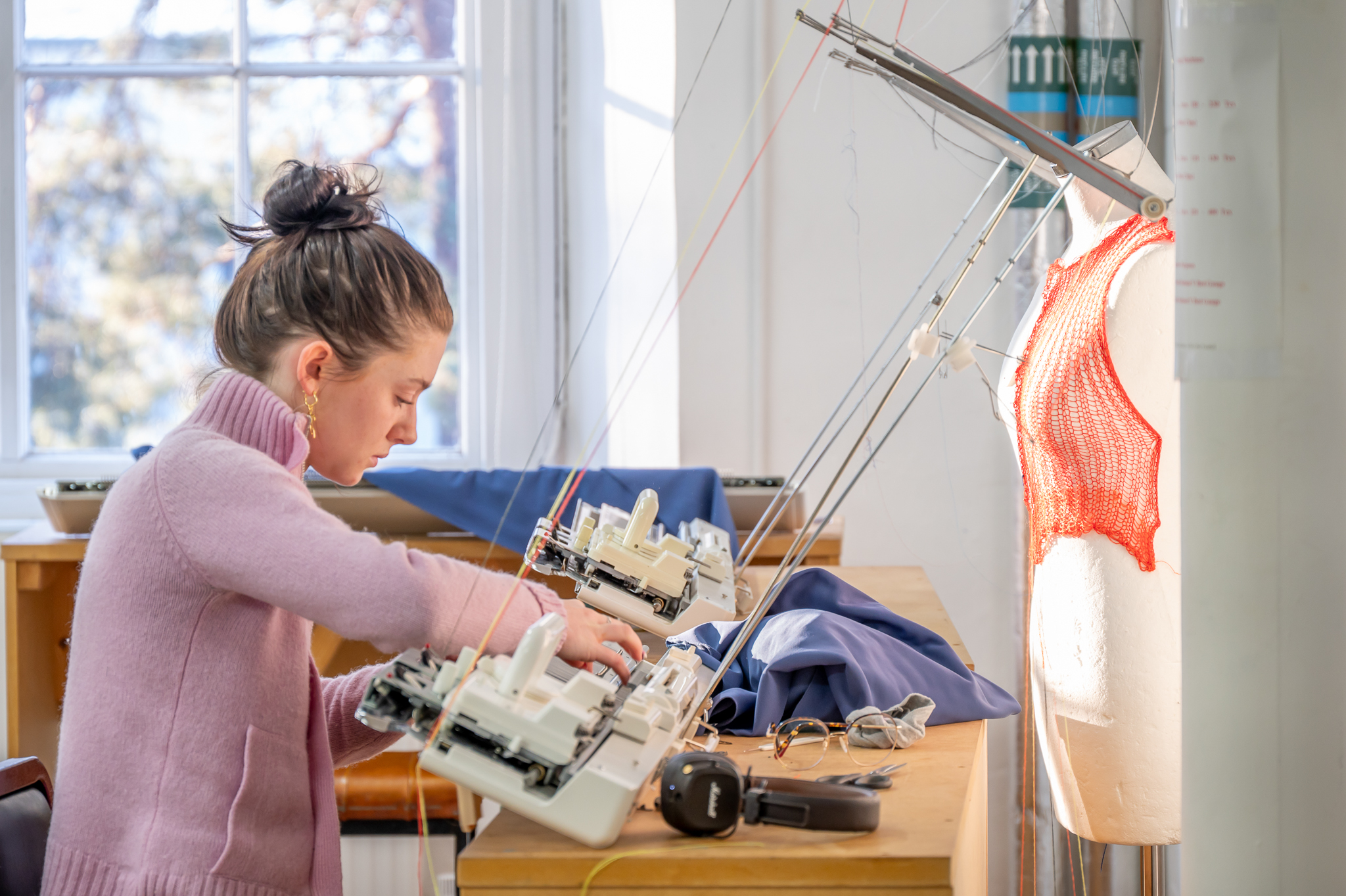 Student using textiles equipment