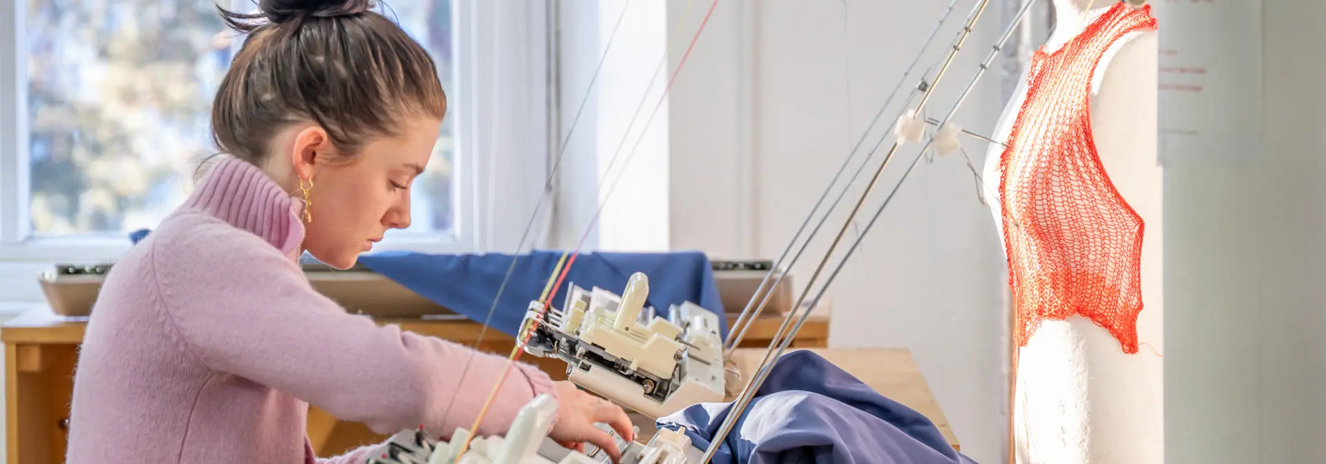 Student using textiles equipment