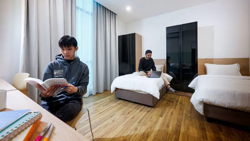 Twin bedroom with students studying