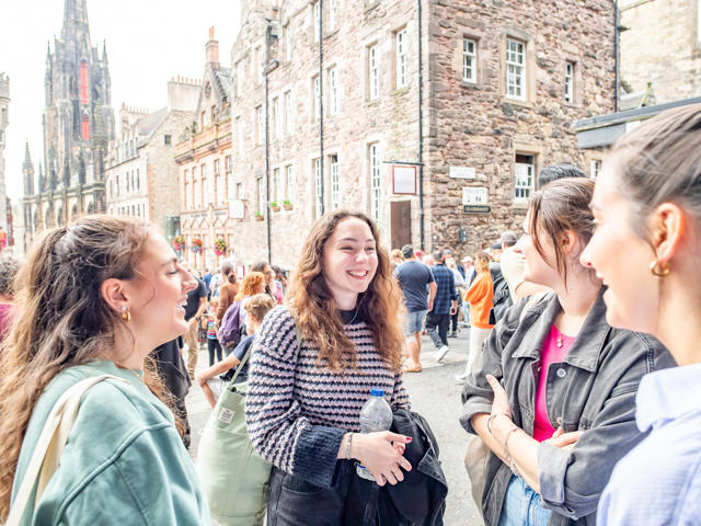 A busy street with individuals talking animatedly in a group.