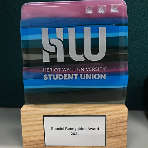 Blue and purple coloured glass 'Special Recognition Award' mounted on a wooden base
