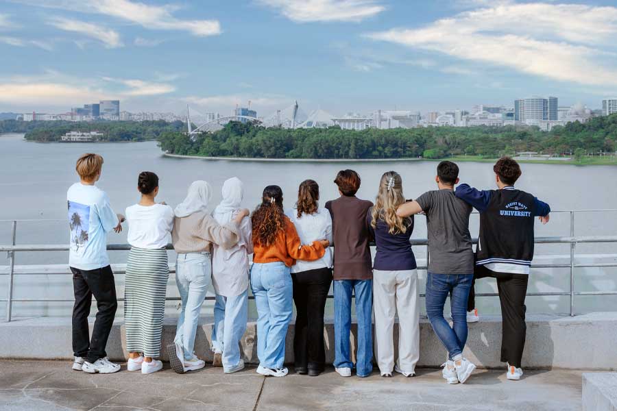 Students gather to admire the panoramic view of the city skyline in the distance.