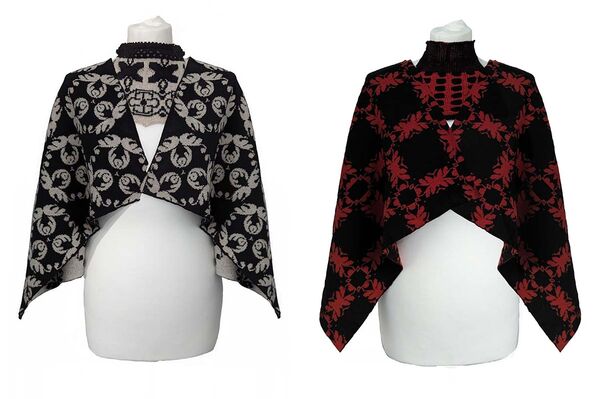 Two shawls with black and red designs, showcasing distinct styles. One features intricate patterns, while the other has a simpler design.