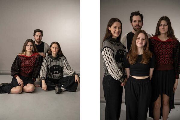 A man and three women model clothes and stand posing for the camera