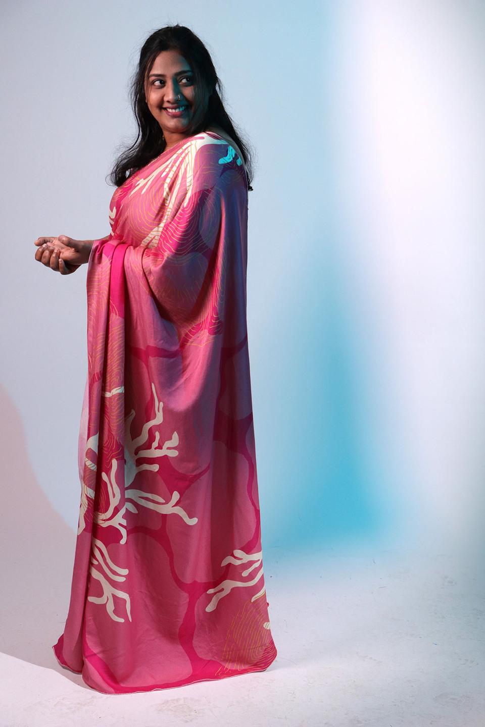 Side view of woman wearing pink sari from the collection 'Revive' by Anula Narasimhan