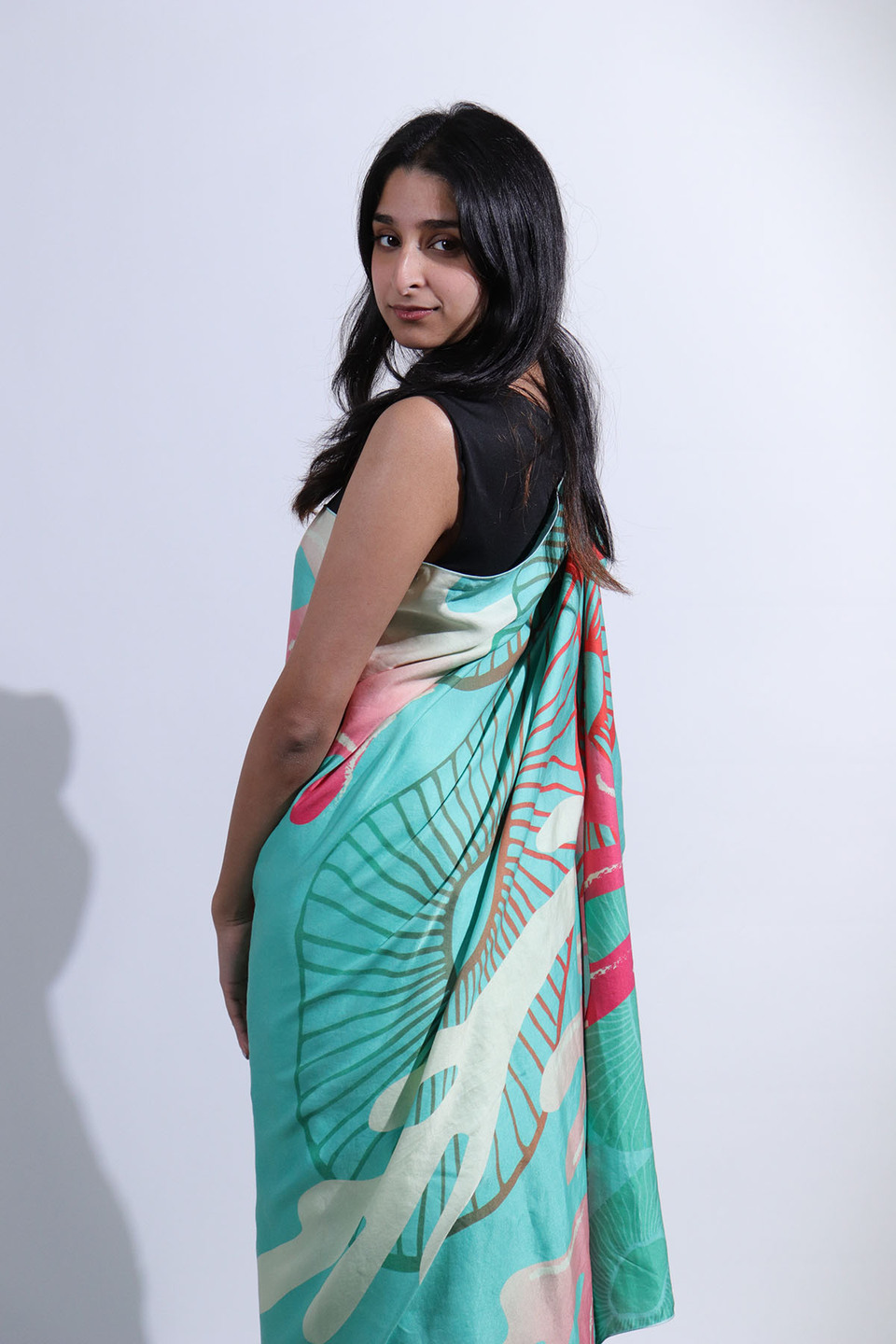 Side view of woman wearing pale blue sari from the collection 'Revive' by Anula Narasimhan