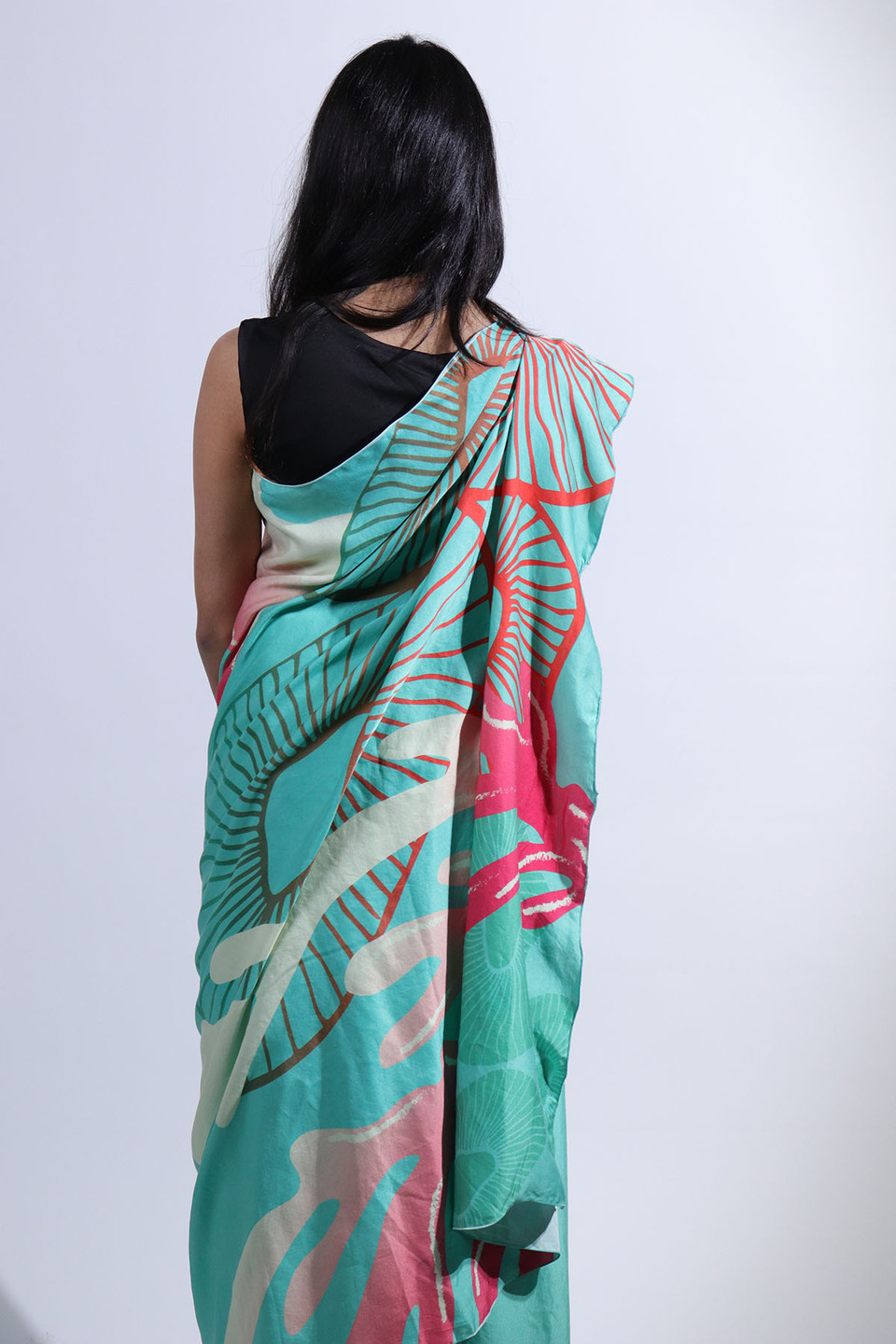 Rear view of woman wearing pale blue sari from the collection 'Revive' by Anula Narasimhan