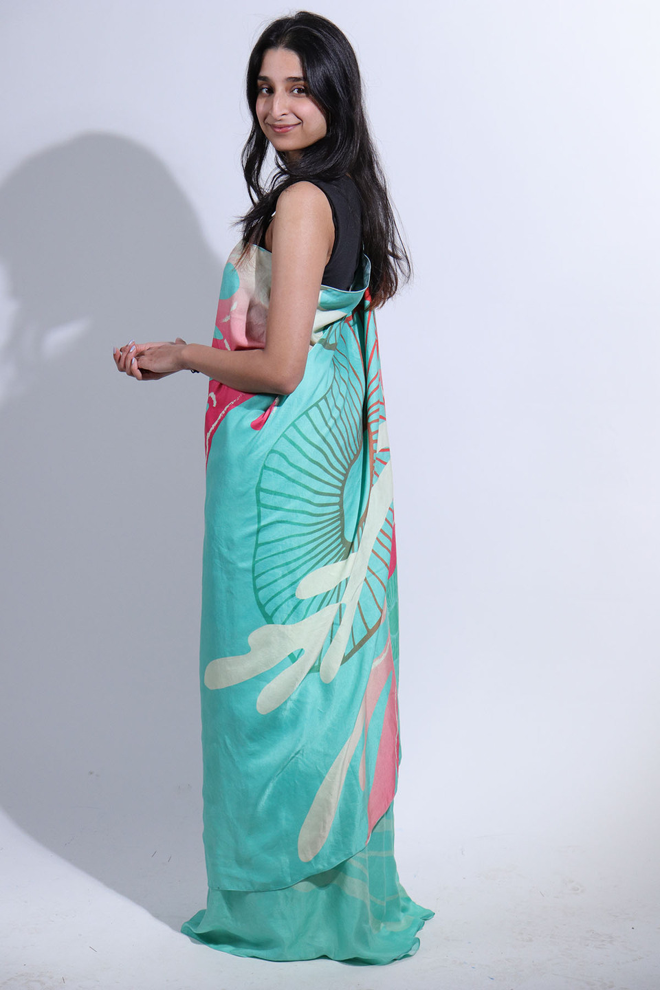 Side view of woman wearing pale blue sari from the collection 'Revive' by Anula Narasimhan