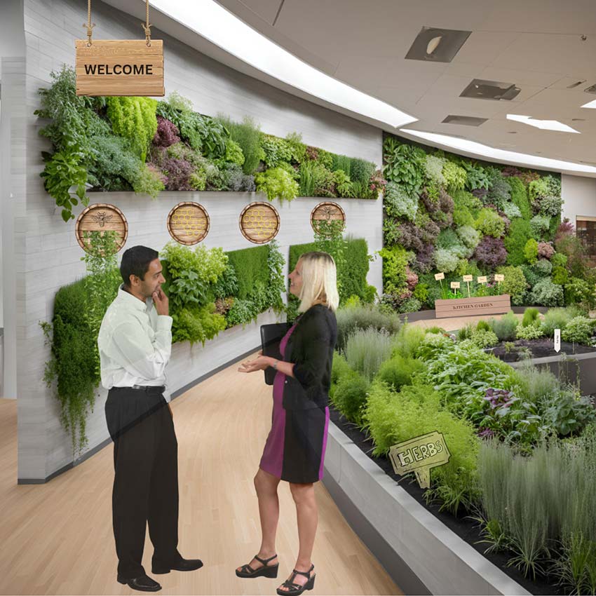 A man and woman standing in front of a lush green wall of plants.