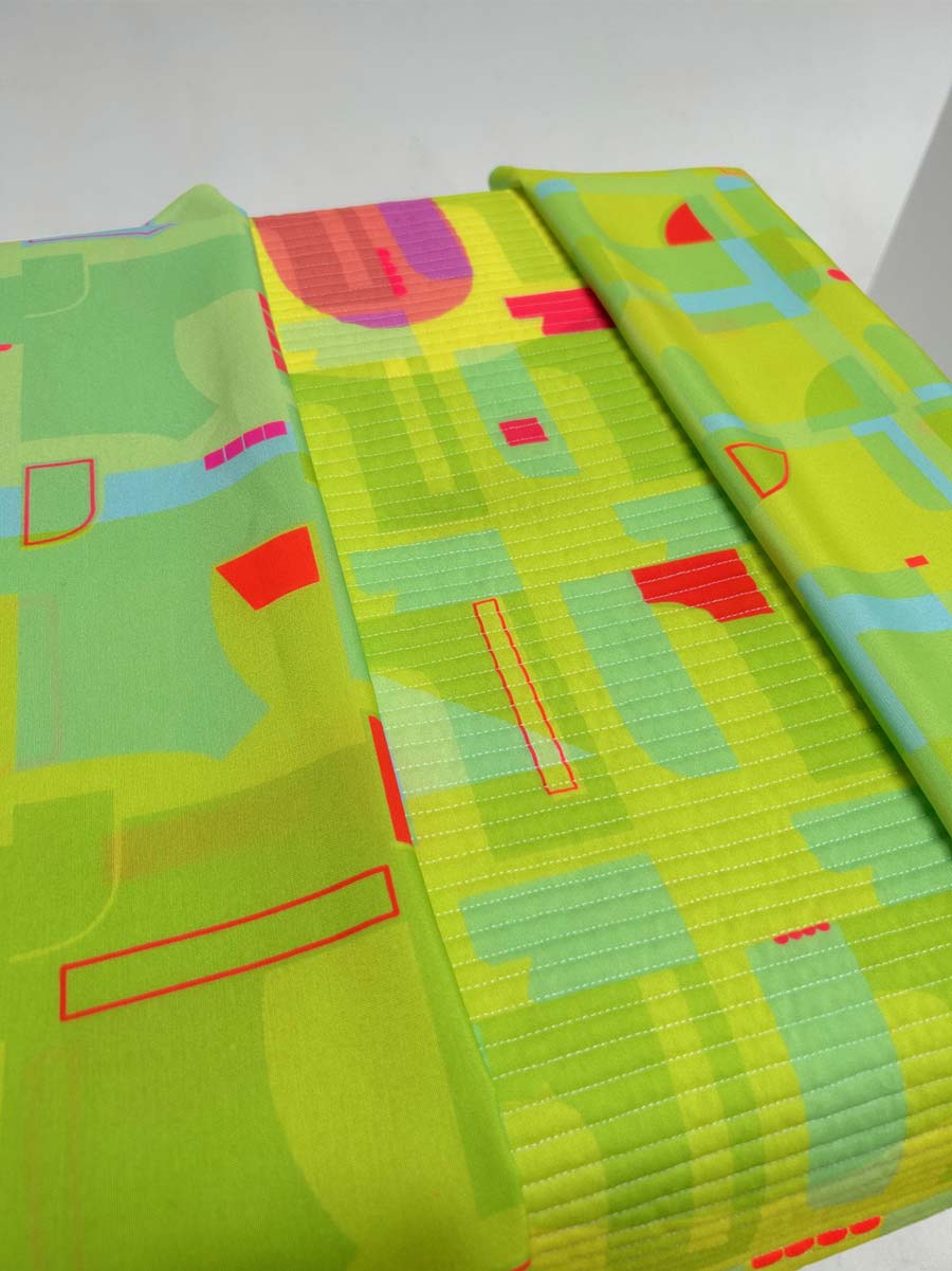 A vibrant fabric with a green and red geometric pattern