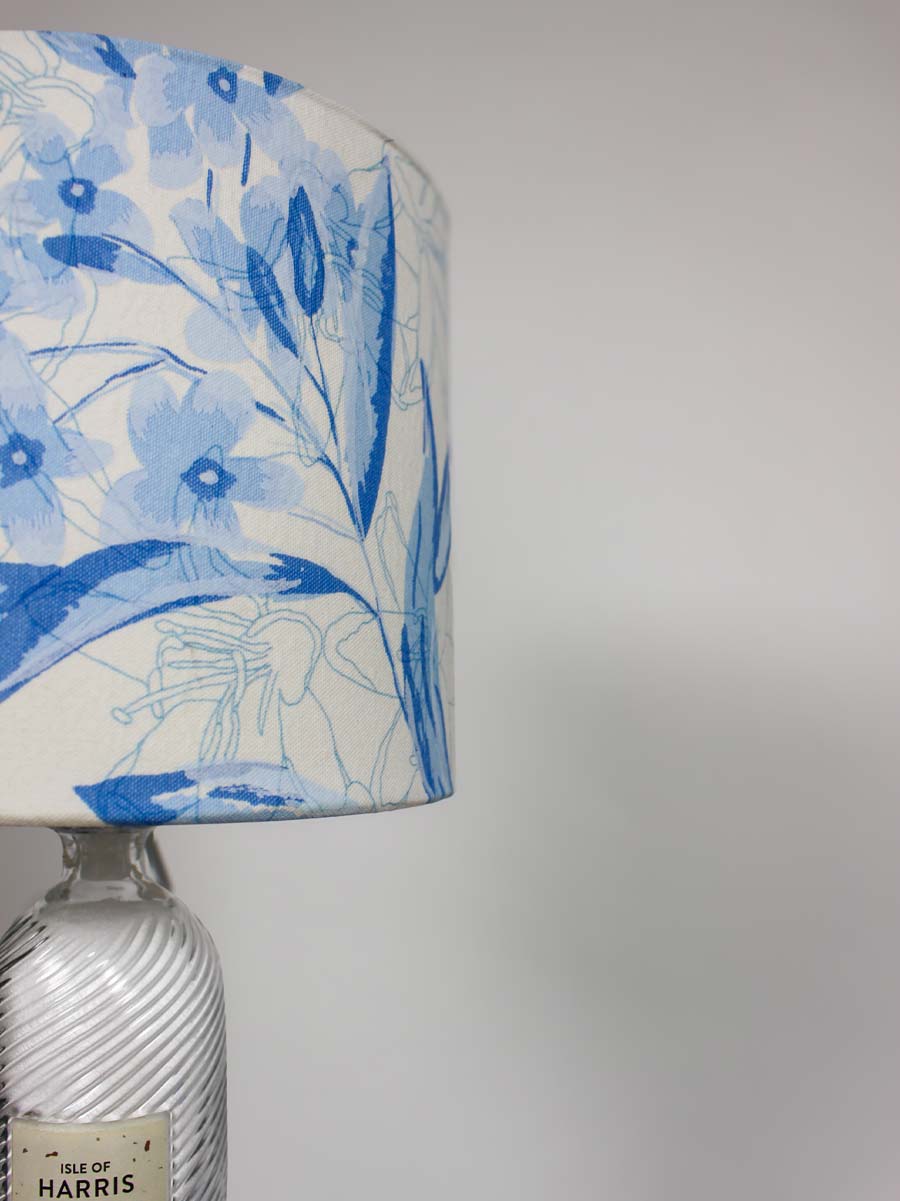 A decorative lamp with a blue and white floral print