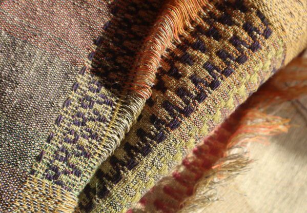 A vibrant, close-up image of a colorful scarf, showcasing its intricate patterns and rich hues.