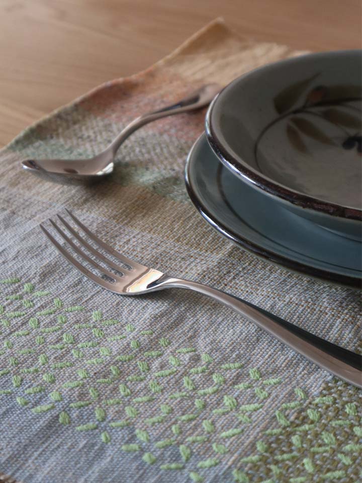 Elegant table arrangement with plate, knife, and textile napkins.