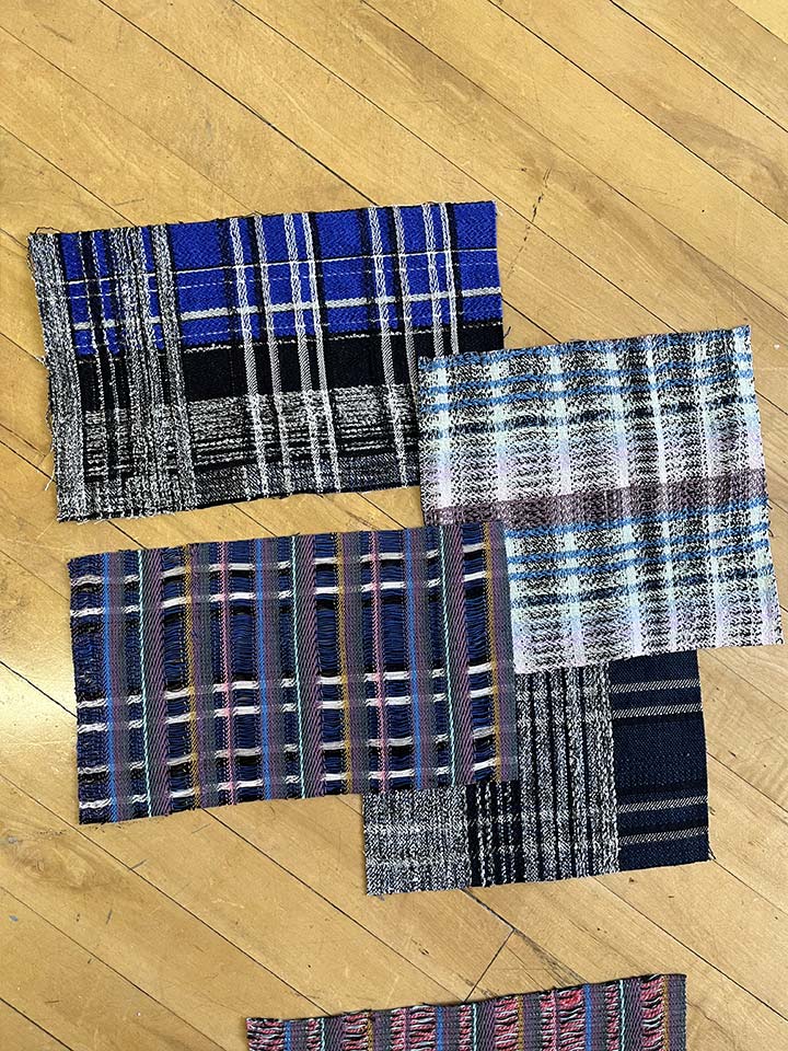 Four colored plaids on a wooden floor.