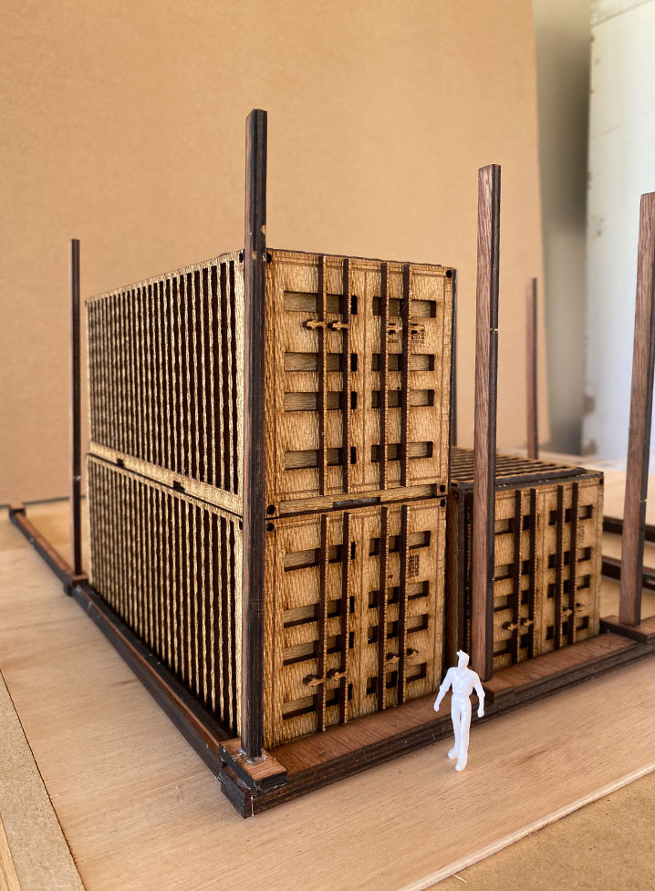 Building model with wooden crates on top, representing construction site concept.