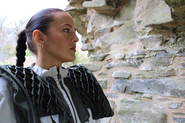 Close up of woman modelling a Karen Heath design in the gateway to the ruins of a castle