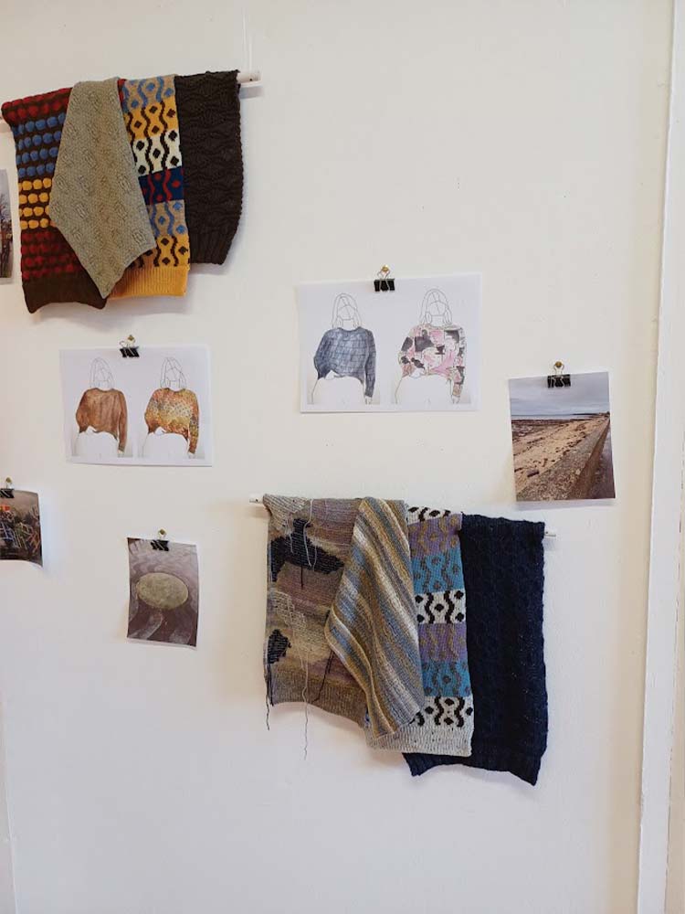 A wall adorned with sketches and knitted items hanging, showcasing a delightful blend of memories.